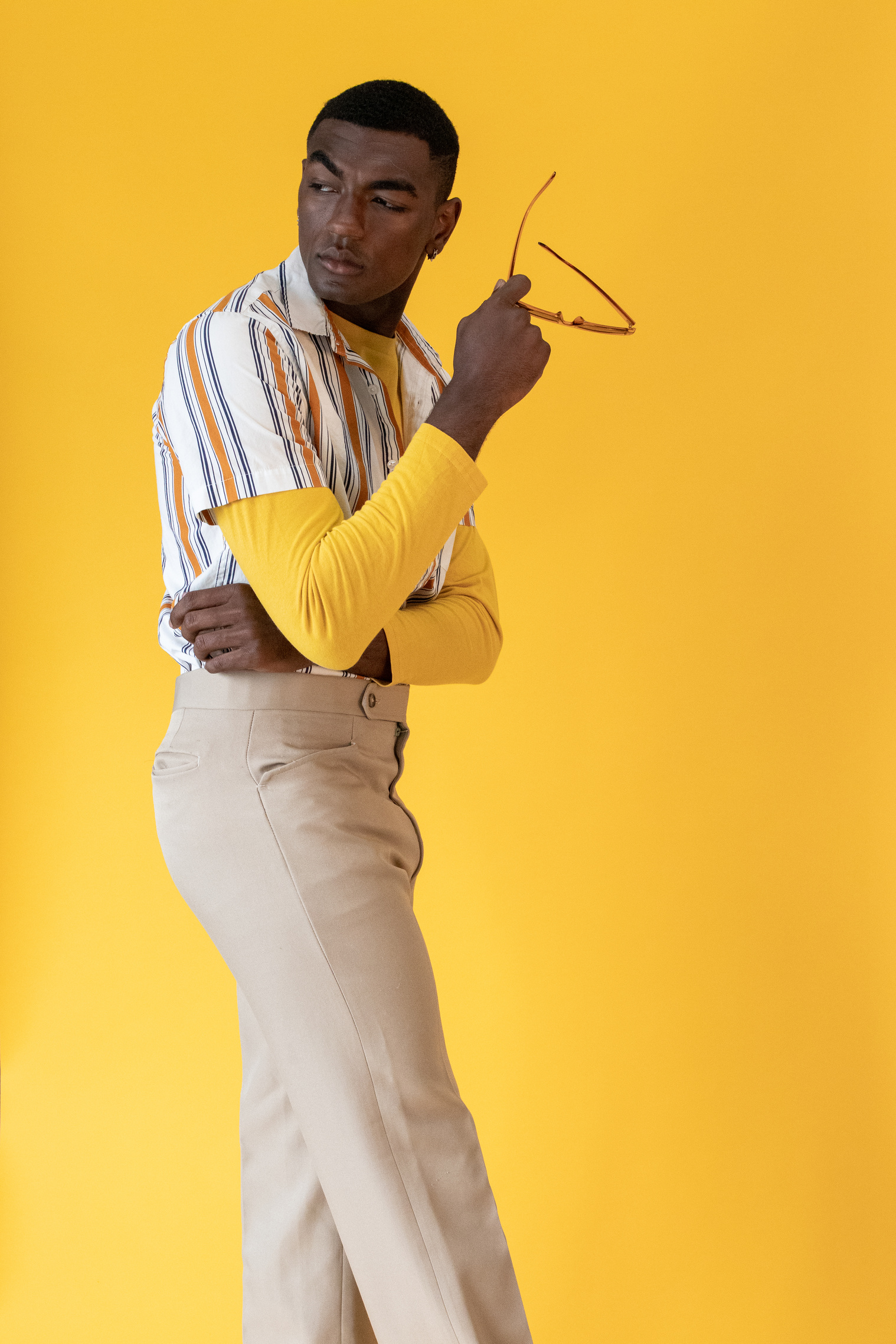 Portrait of a Stylish Man on Yellow Background