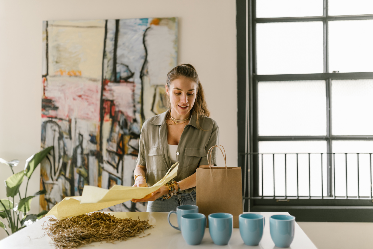  A Woman Packing Mugs