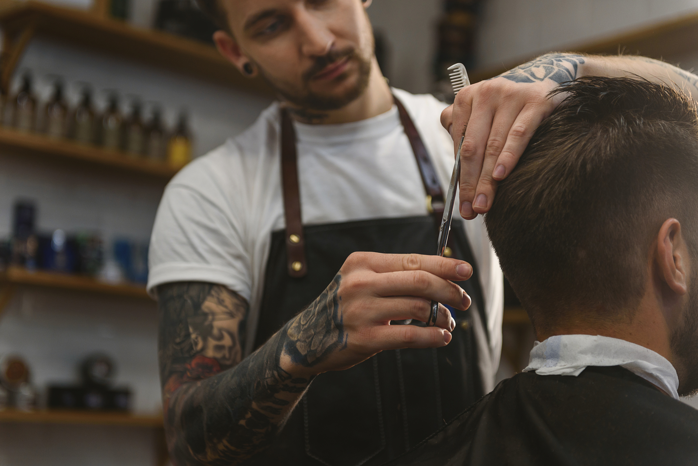 barber cutting hair of a man