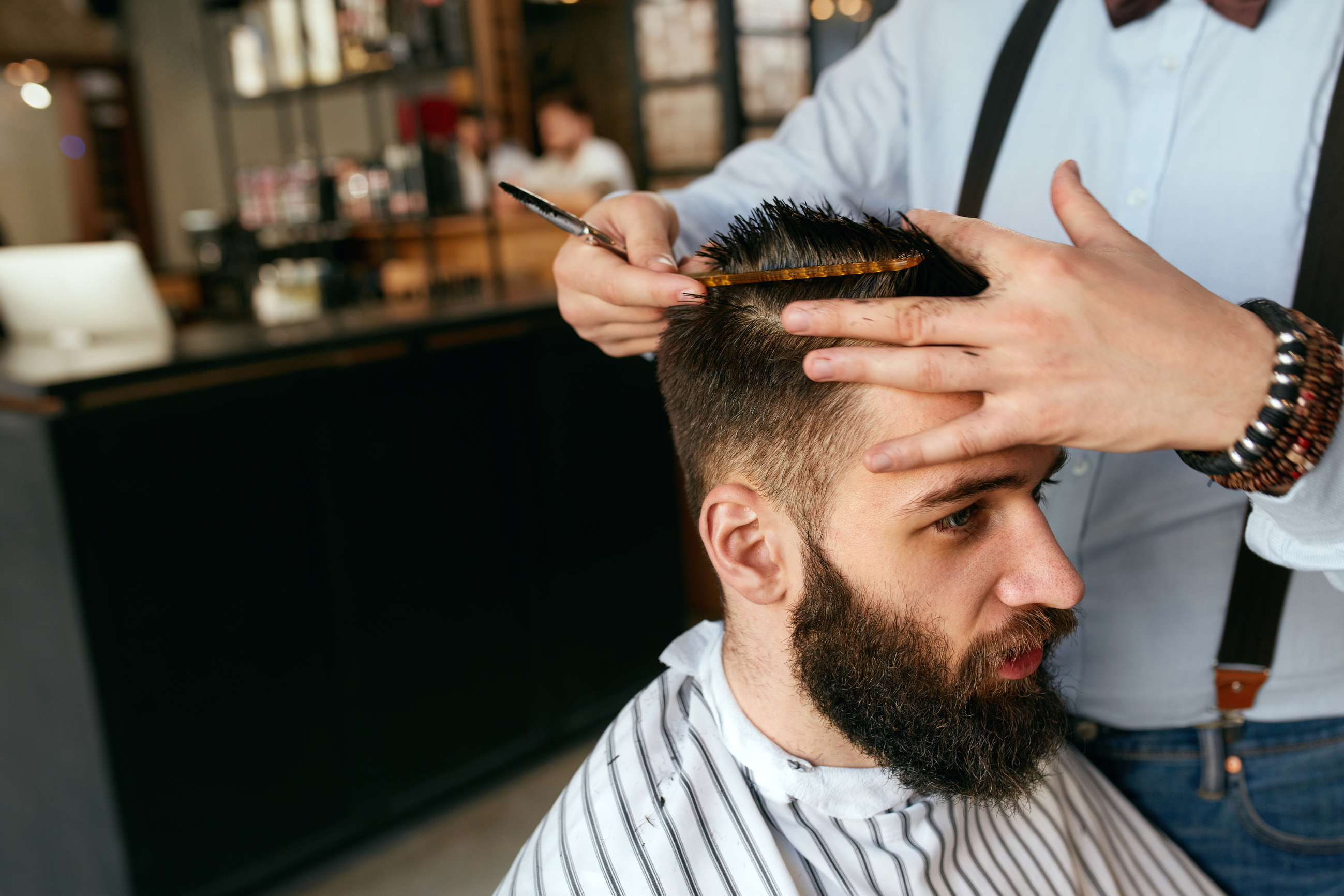 Men Haircut. Barber Cutting Man's Hair In Barber Shop
