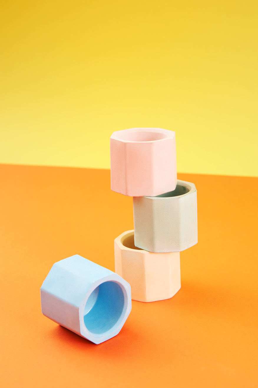 Stack of Vases on Orange Background