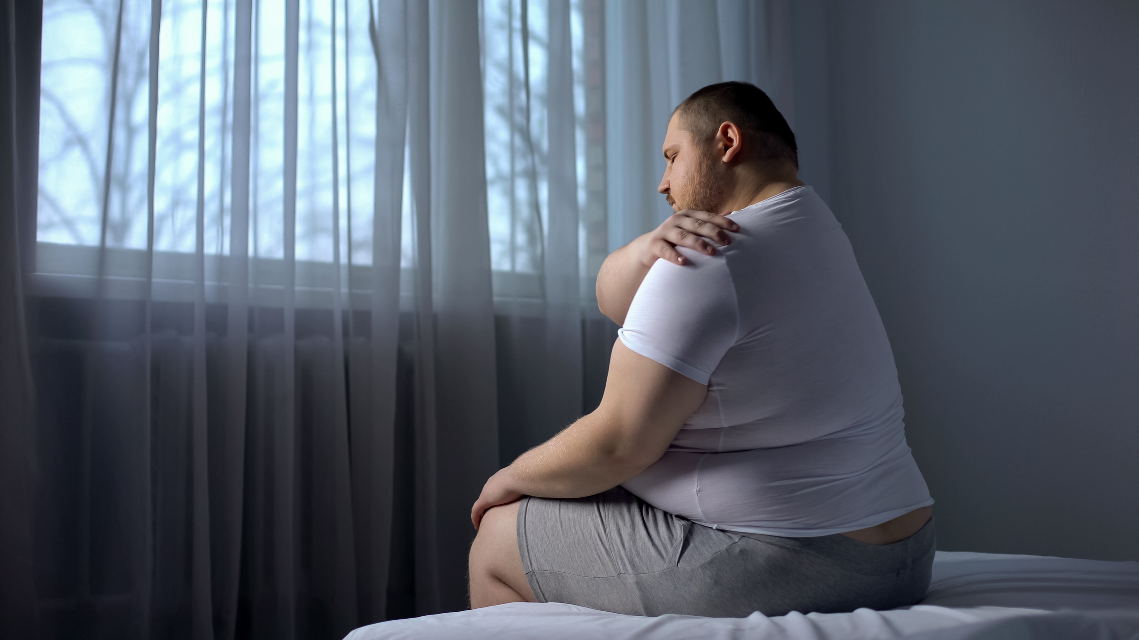 Plus Size Man Massaging Shoulder Muscles