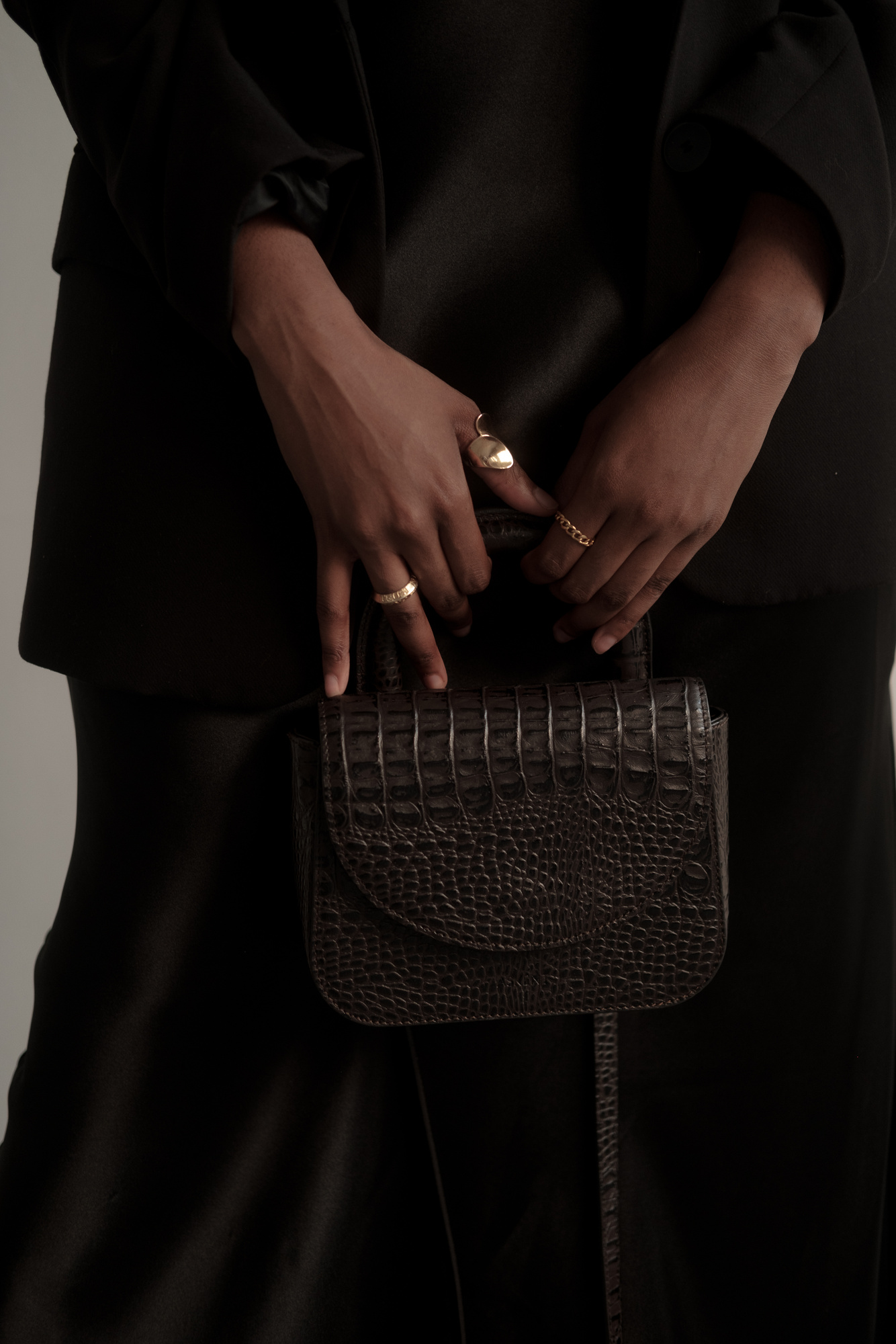 Woman with Black Clothes Holding Black Purse