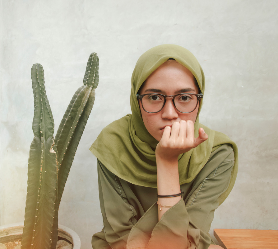 Portrait of a Young Woman near Cactus Plant