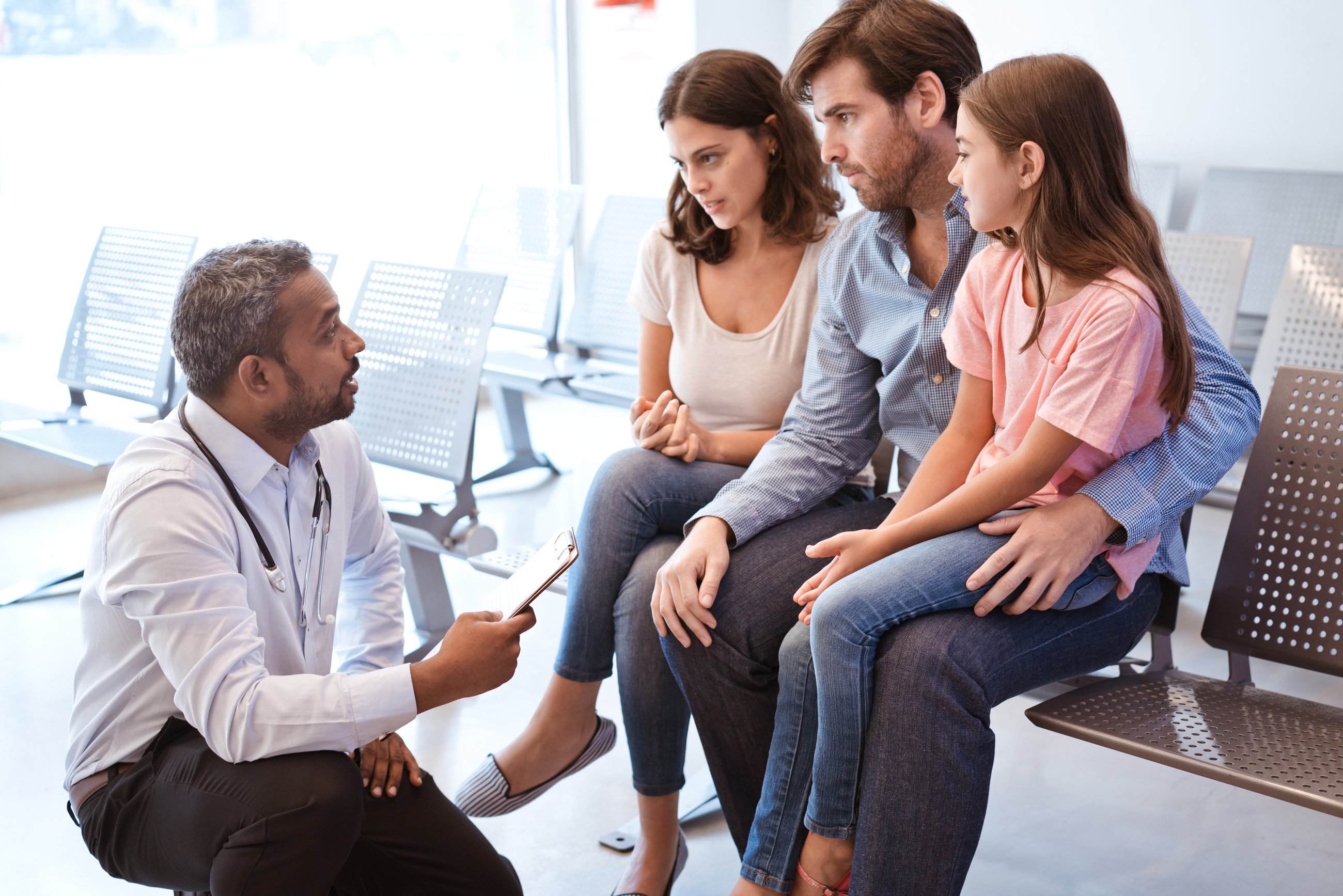 Doctor discussing with girl's family at hospital